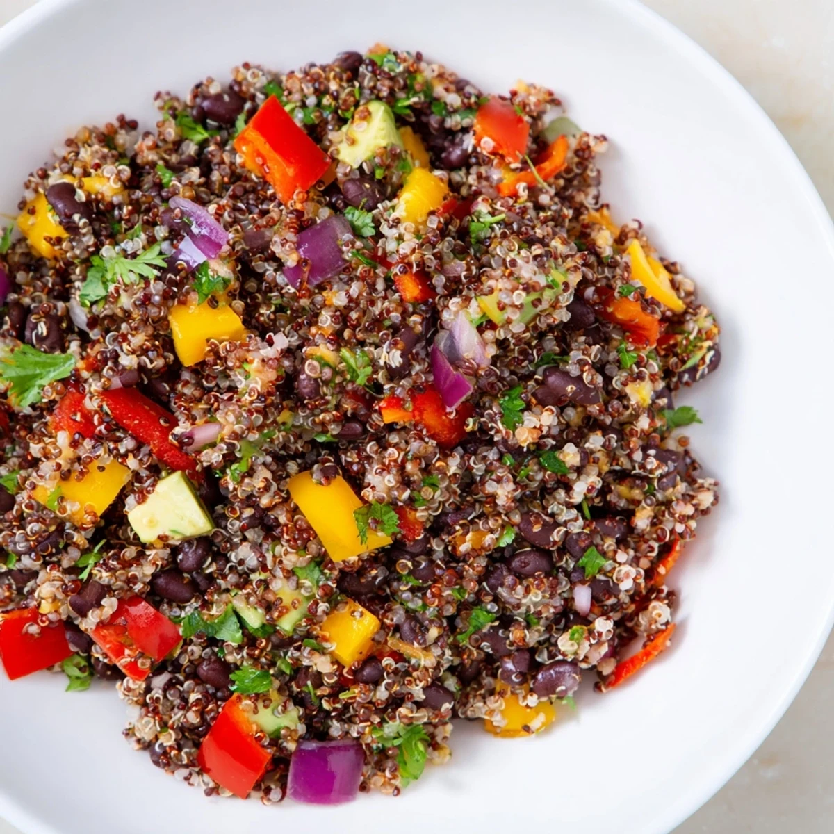 Fluffy quinoa and black bean salad bursting with fresh veggies finished with a zesty lime dressing.