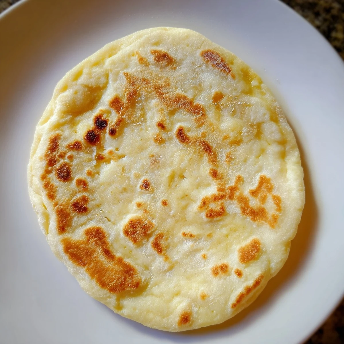 Golden, blistered Cottage Cheese Flatbread, ready to be ripped open and dipped into your favorite spreads.