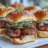 Freshly baked Touchdown Brat Sliders served hot with melted cheese and savory bratwurst patties.  