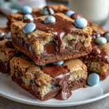 Chewy Cadbury Egg Cookie Bars with pastel M&Ms, loaded with colorful candy and rich chocolate chunks.