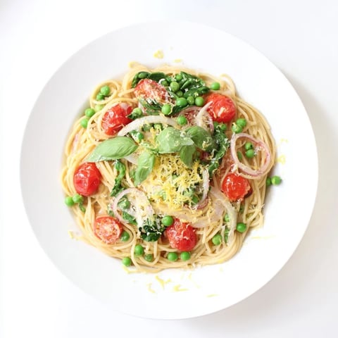 Bright green peas and wilted spinach mingle with al dente spaghetti and bright cherry tomatoes in this Spring Veggie One-Pot Spaghetti.