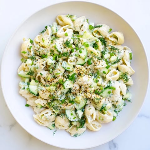 Cucumber Crunch Pasta Salad featuring tender shell pasta, diced cucumbers, and fresh dill in a creamy dressing topped with everything bagel seasoning.