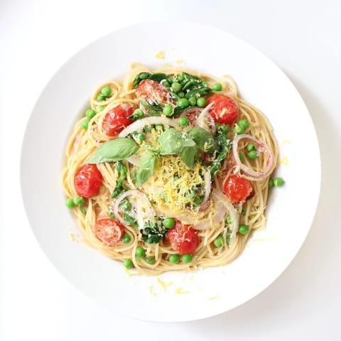 Bright green peas and wilted spinach mingle with al dente spaghetti and bright cherry tomatoes in this Spring Veggie One-Pot Spaghetti.