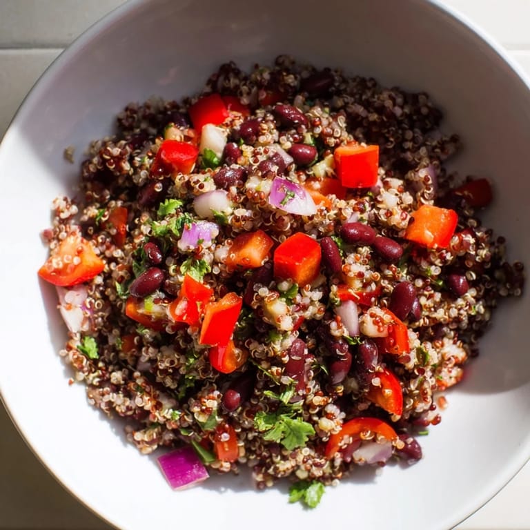 A healthy photo of colorful quinoa and black bean salad, perfect for a light vegetarian lunch.