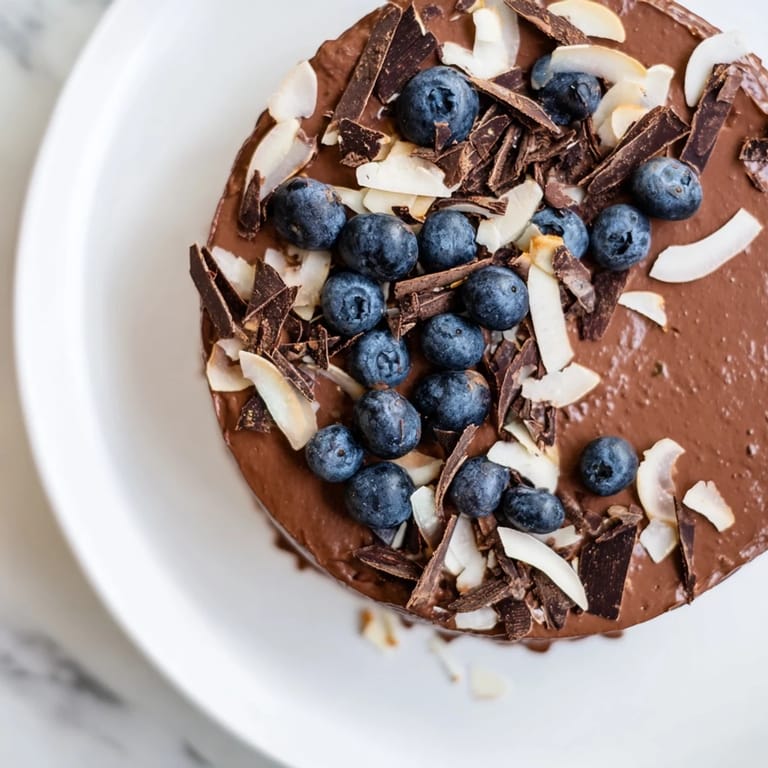 Enjoy a decadent chocolate avocado mousse, a healthy, chilled dessert with dark chocolate shavings.