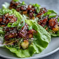 Juicy teriyaki chicken and sweet pineapple wrapped in crisp lettuce leaves with fresh vegetables.  